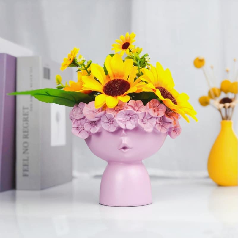 Vase of a woman's head with a crown of flowers