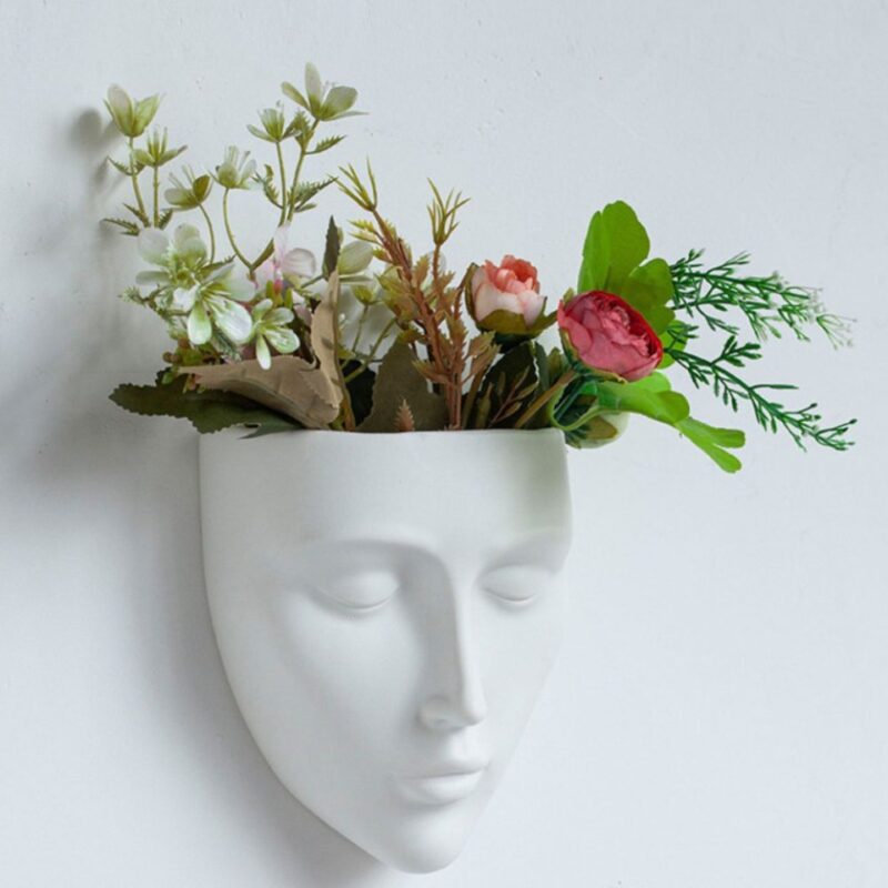 White face-shaped vase